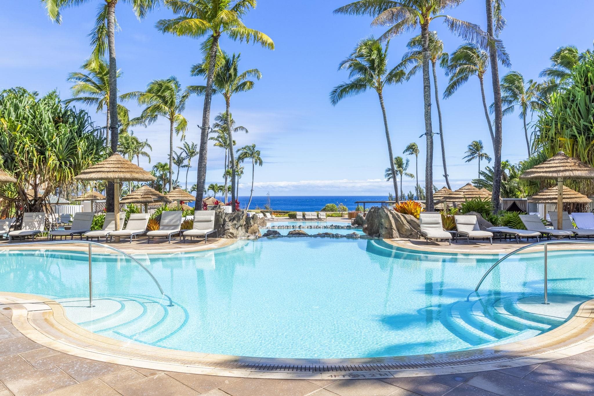 1 Ritz Carlton Drive, Unit 122123 Lahaina, HI 96761 - Photo 32 of 50 a view of a swimming pool with a table and chairs potted plants