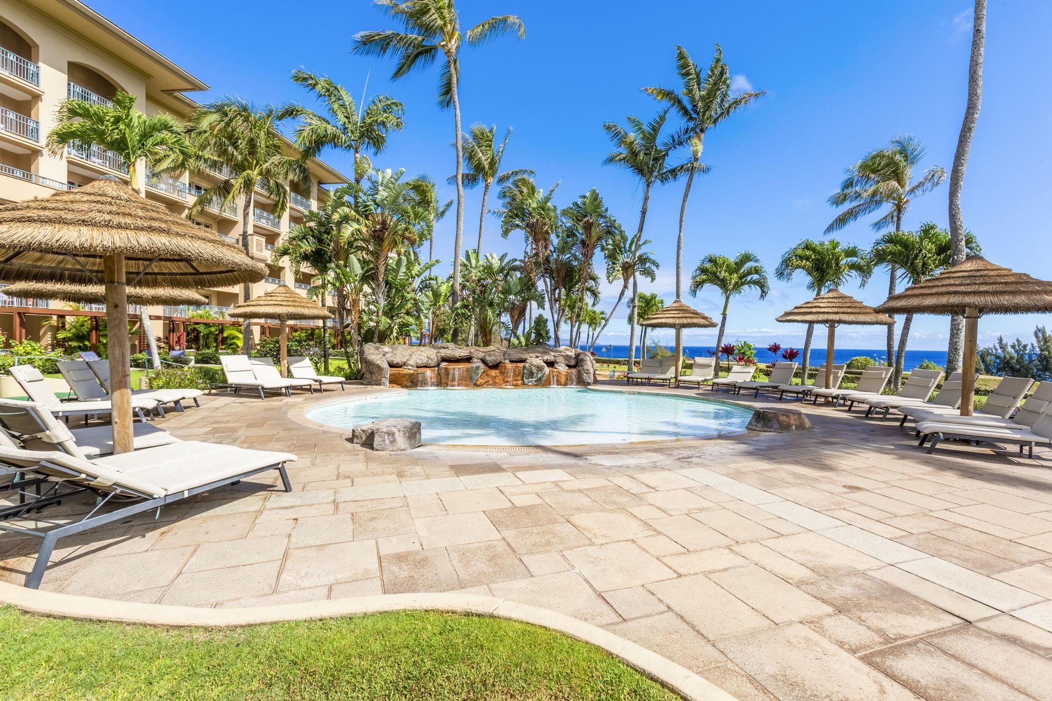 1 Ritz Carlton Drive, Unit 122123 Lahaina, HI 96761 - Photo 34 of 50 a view of a swimming pool with lawn chairs under an umbrella