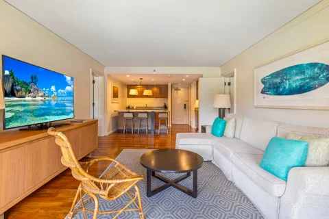 a living room with furniture a rug and a floor to ceiling window
