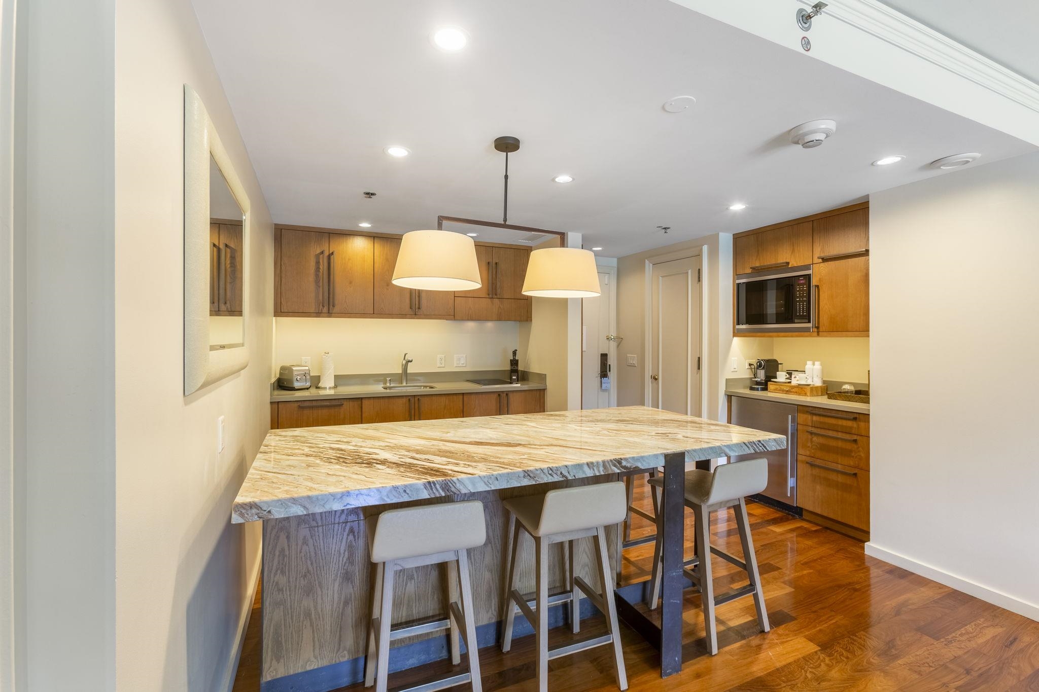 1 Ritz Carlton Drive, Unit 122123 Lahaina, HI 96761 - Photo 6 of 50 a kitchen with stainless steel appliances granite countertop a table chairs sink and cabinets