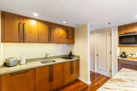 a kitchen with stainless steel appliances granite countertop a sink and cabinets