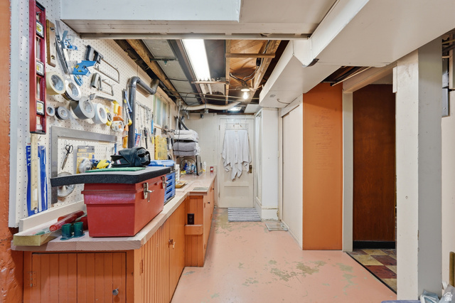 7576 South Jefferson Street Midvale, UT 84047 - Photo 35 of 53 Utility space featuring an extensive built-in workbench with integrated storage cabinetry