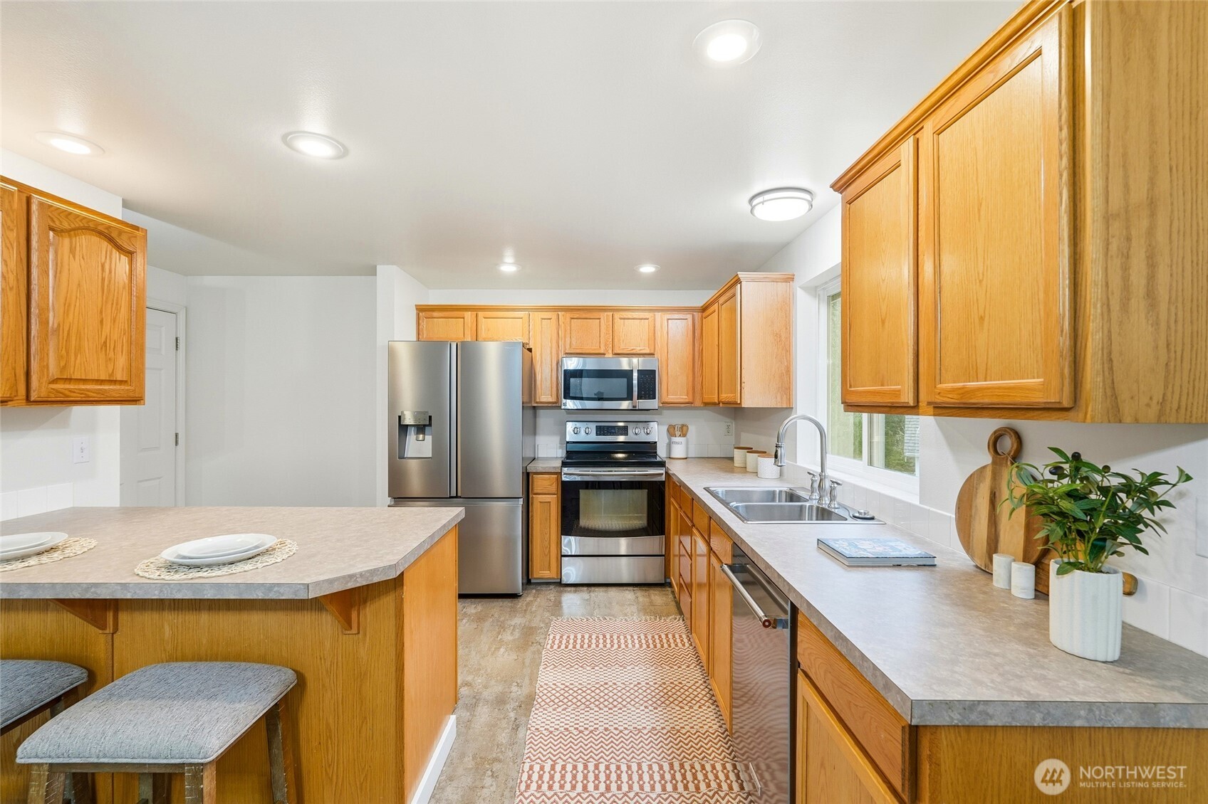 18219 58th St Court East Lake Tapps, WA 98391 - Photo 15 of 40 a kitchen with stainless steel appliances granite countertop a sink stove and cabinets