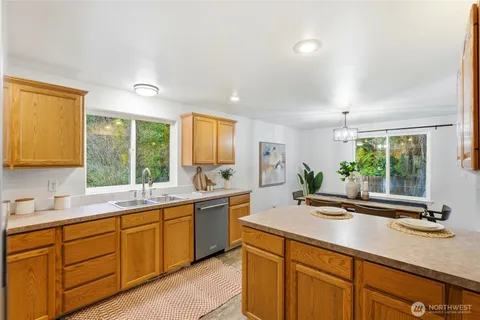 a kitchen with sink window and cabinets