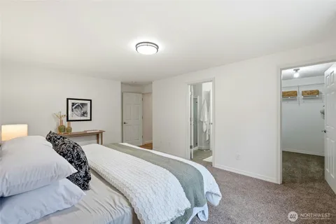 a bedroom with a bed and a view of bathroom