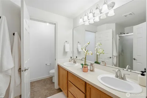a bathroom with a sink vanity granite and a mirror