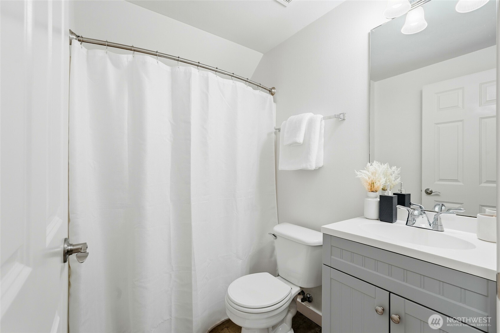 18219 58th St Court East Lake Tapps, WA 98391 - Photo 25 of 40 a bathroom with a sink a toilet and a mirror