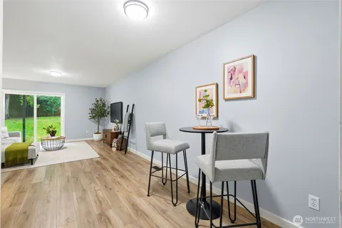 a living room with furniture a table and a large window