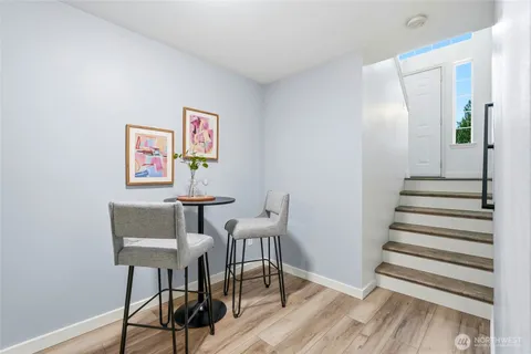 a view of a room with furniture and wooden floor