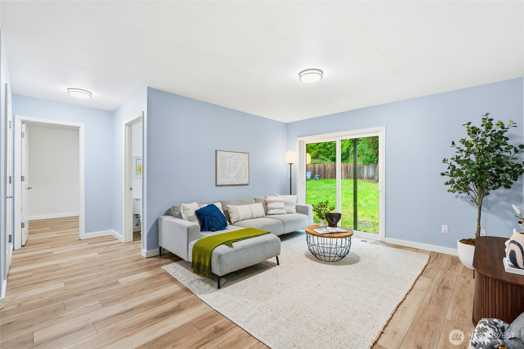 18219 58th St Court East Lake Tapps, WA 98391 - Photo 28 of 40 a living room with furniture potted plant and a window