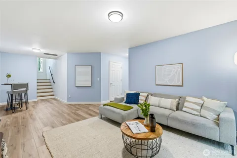 a living room with furniture and a dining table