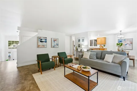 a living room with furniture a rug and a table