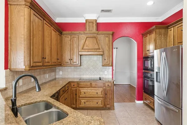 a kitchen with a sink stove and cabinets