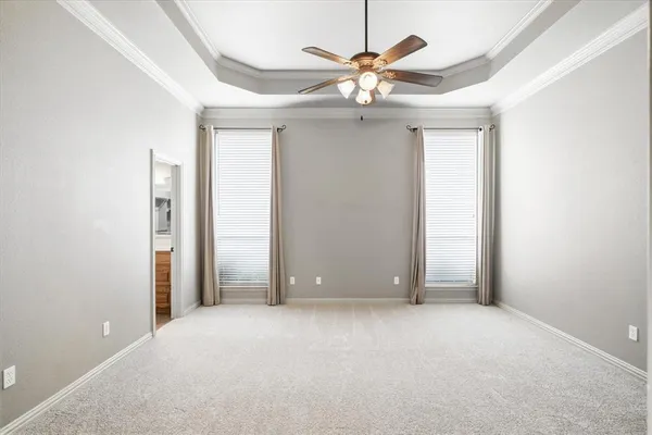 a view of an empty room with a ceiling fan