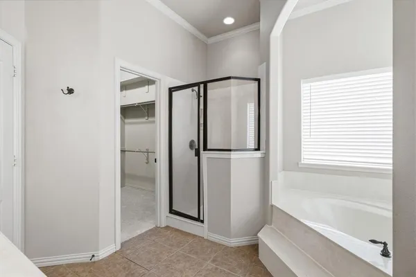 a front view of a house with a garden and yard