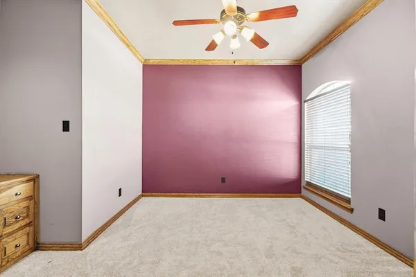 a big room with chandelier fan and closet