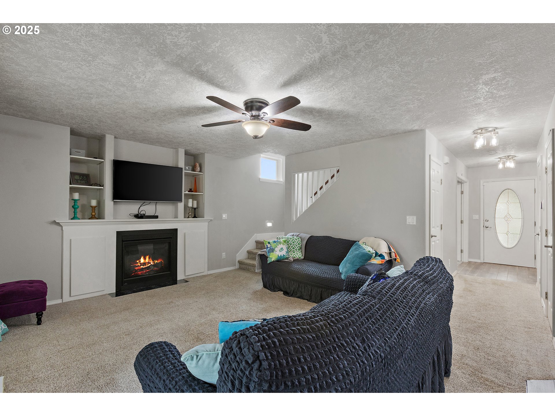 7771 St Charles Street Northeast Keizer, OR 97303 - Photo 15 of 42 a living room with furniture a fireplace and a flat screen tv