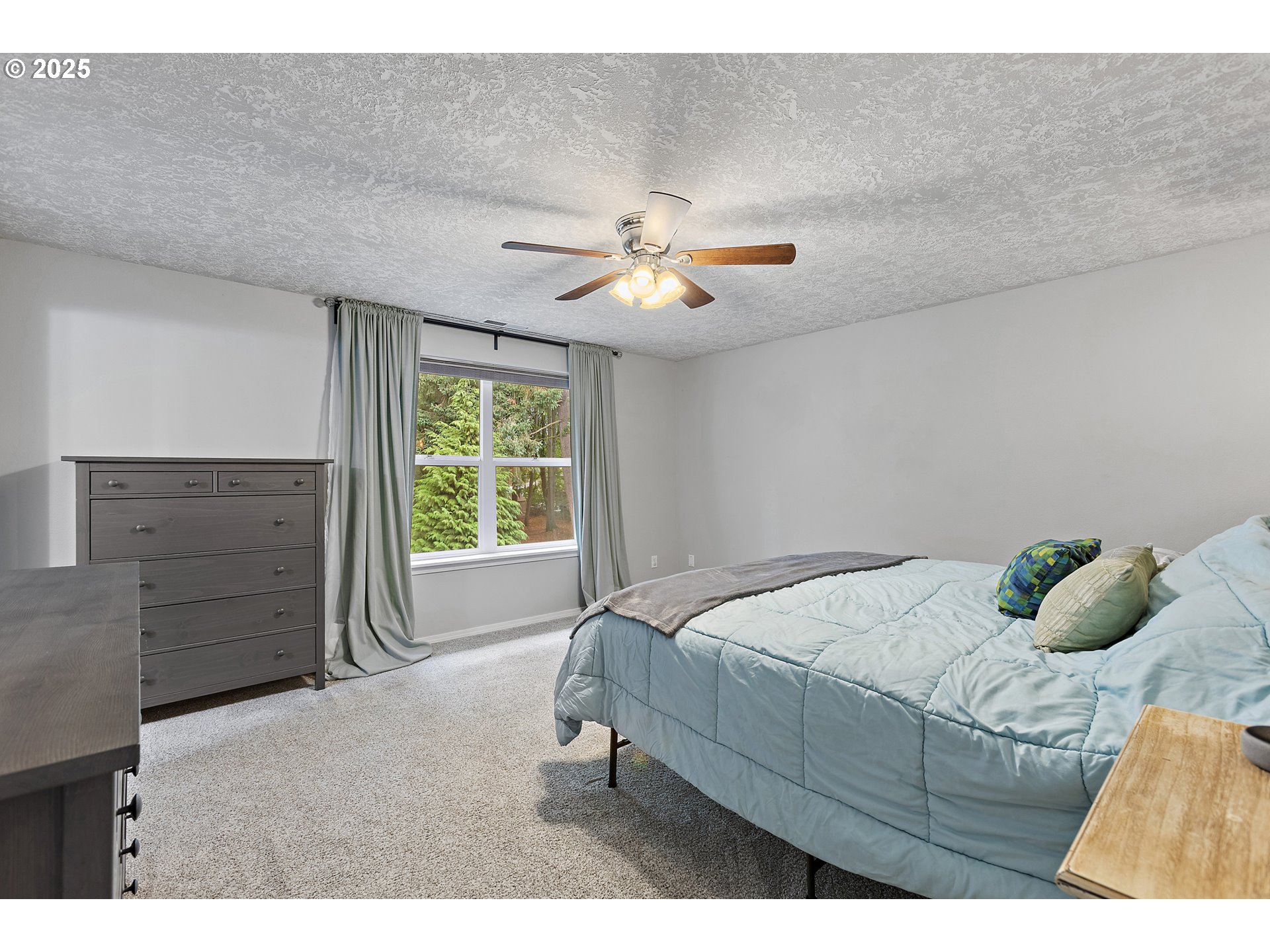 7771 St Charles Street Northeast Keizer, OR 97303 - Photo 24 of 42 a bedroom with a bed and a ceiling fan