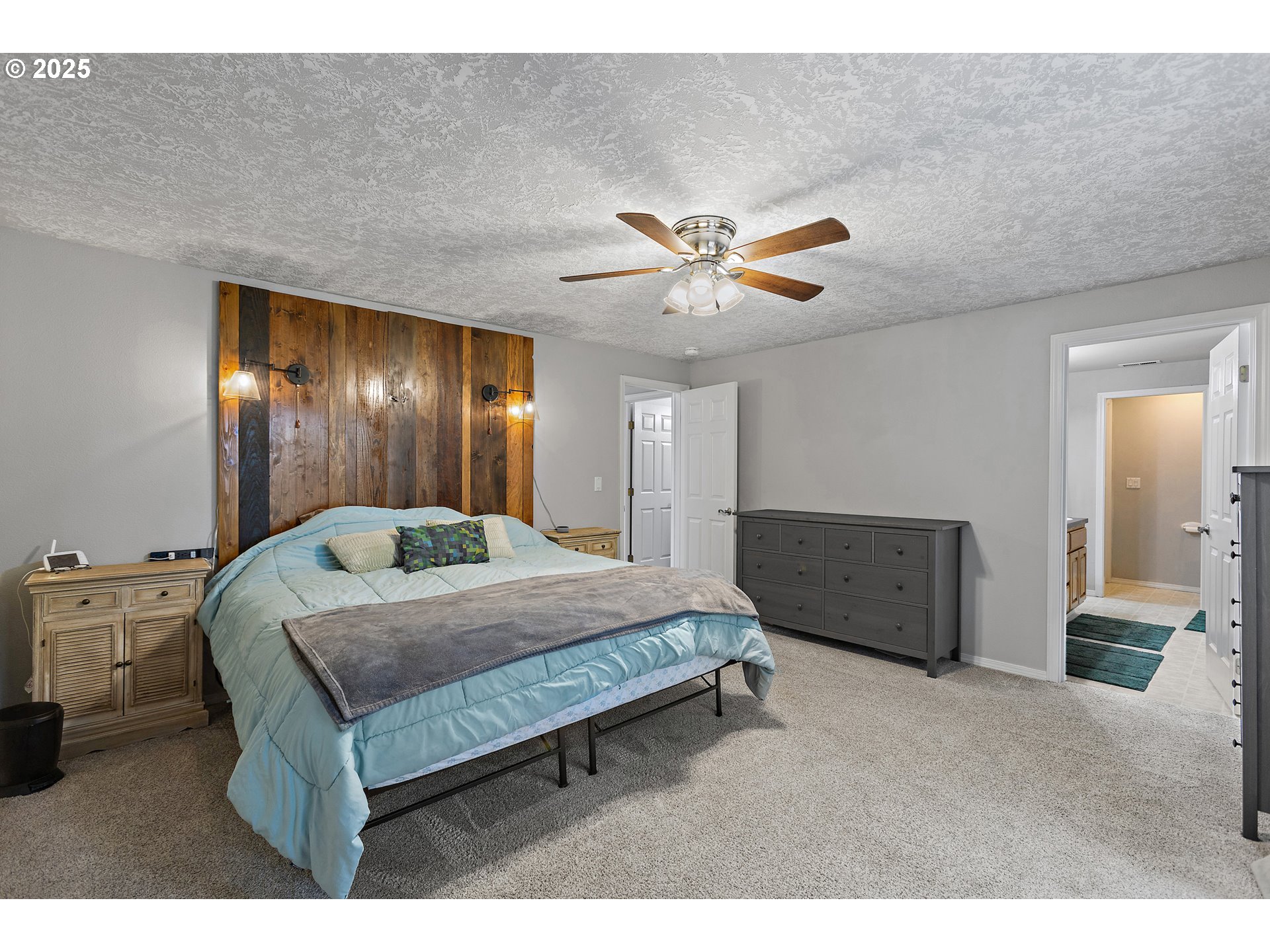 7771 St Charles Street Northeast Keizer, OR 97303 - Photo 25 of 42 a spacious bedroom with a bed and a chandelier