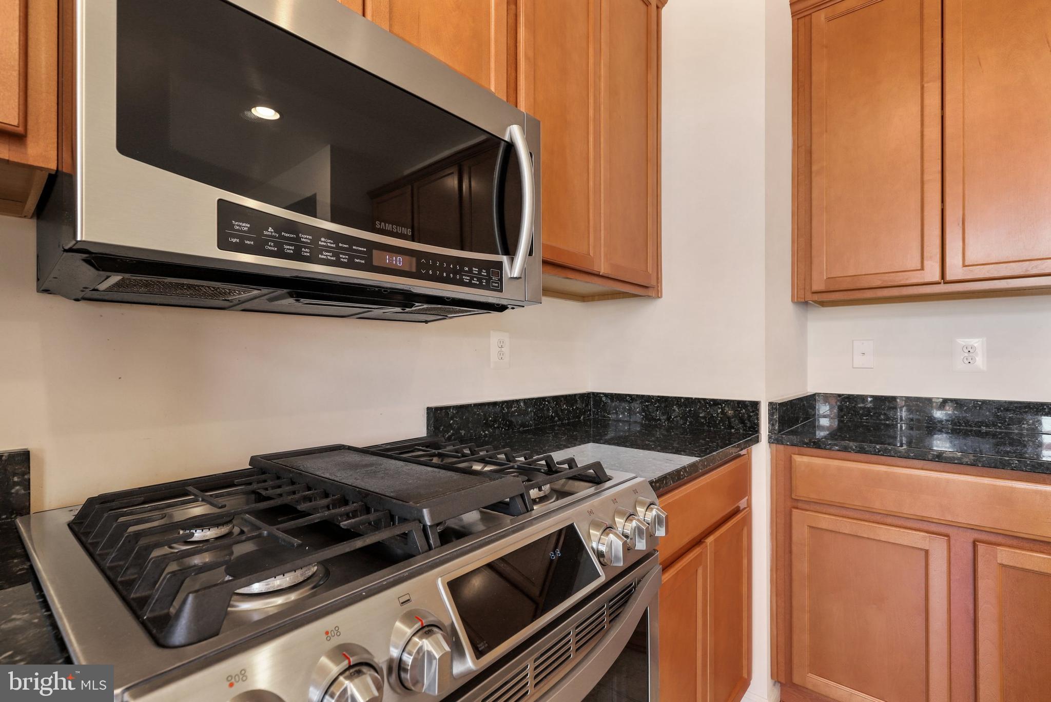 17666 Possum Point Road Dumfries, VA 22026 - Photo 11 of 40 a stove top oven sitting inside of a kitchen