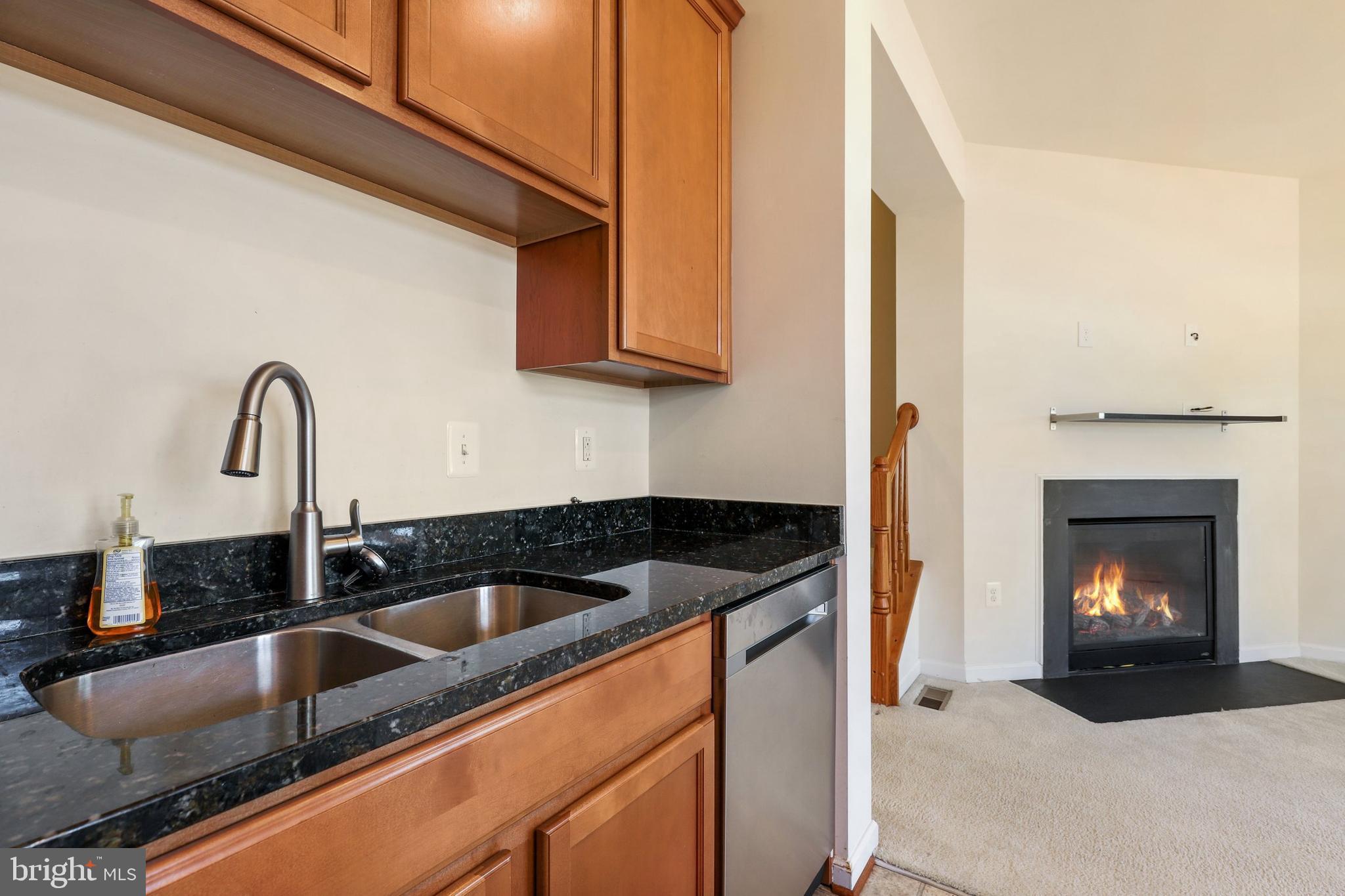 17666 Possum Point Road Dumfries, VA 22026 - Photo 12 of 40 a kitchen with a sink cabinets and a fireplace
