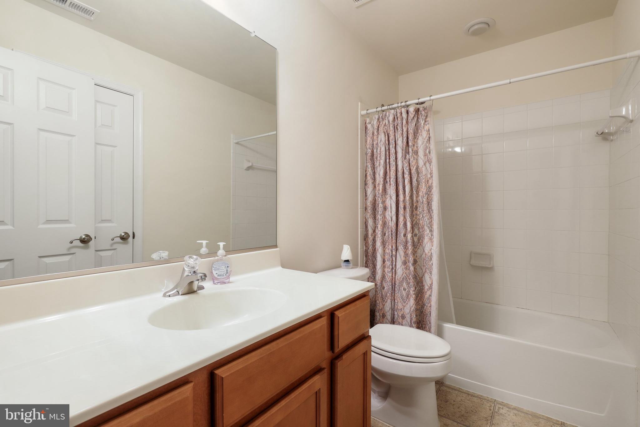 17666 Possum Point Road Dumfries, VA 22026 - Photo 13 of 40 a bathroom with a sink a toilet and shower