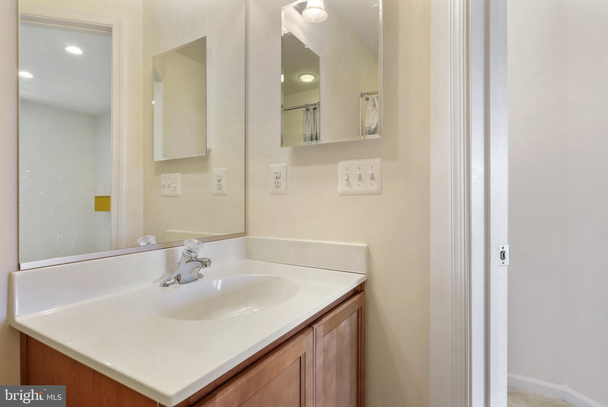 17666 Possum Point Road Dumfries, VA 22026 - Photo 29 of 40 a bathroom with a sink vanity and a mirror