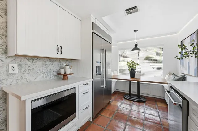 a kitchen with a sink a stove and cabinets