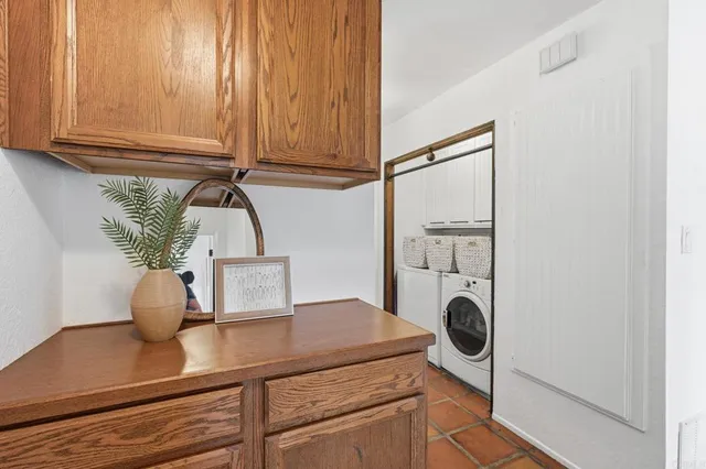 a bedroom with a large bed and a potted plant