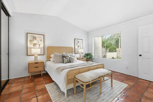 a bedroom with a bed and a television