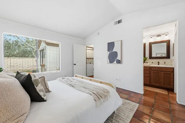 a bathroom with double vanity sinks and a mirror