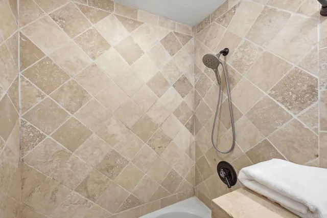 a spacious bedroom with a bed and a flat screen television