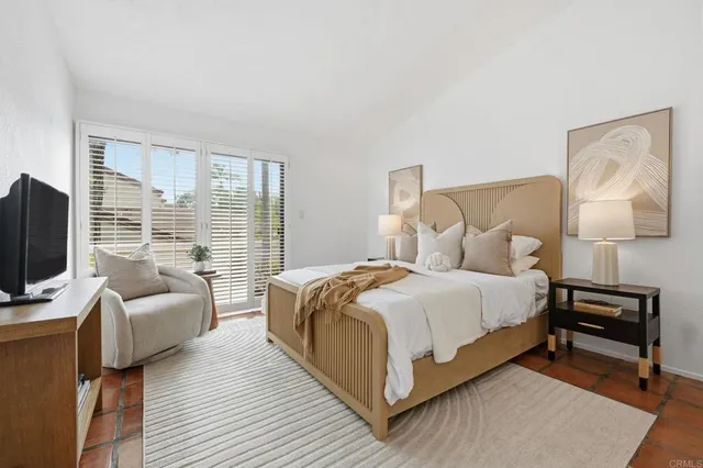 a bedroom with a bed and a flat screen tv