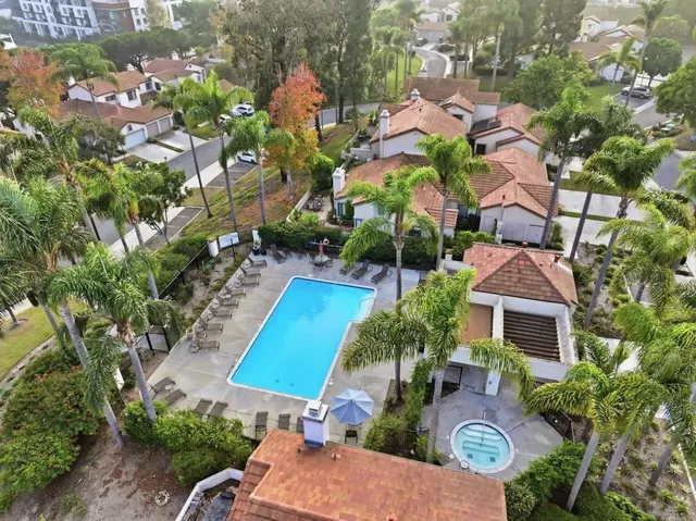 an aerial view of residential houses with outdoor space and river