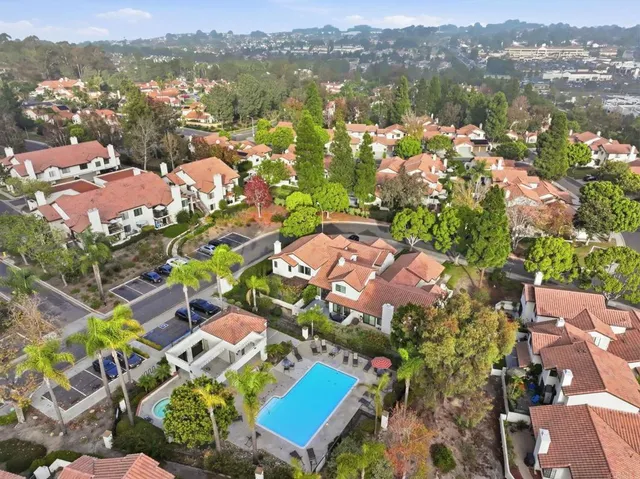 an aerial view of residential houses with outdoor space and river view