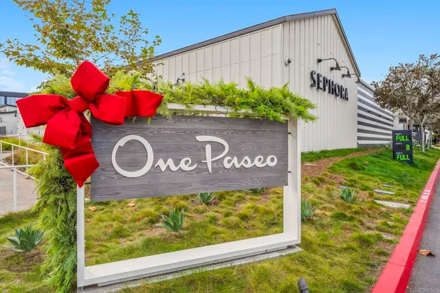 a view of a chairs with potted plants in front of main door