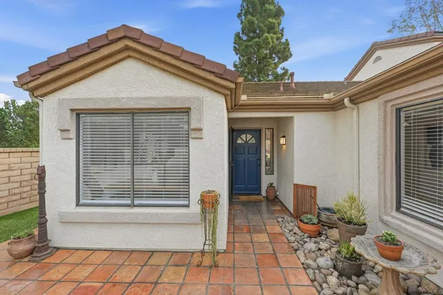 a living room with furniture a large window and a fireplace