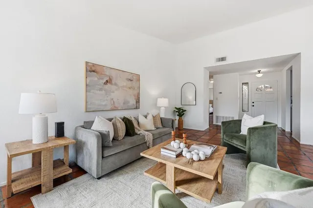 a dining room with furniture a chandelier and wooden floor