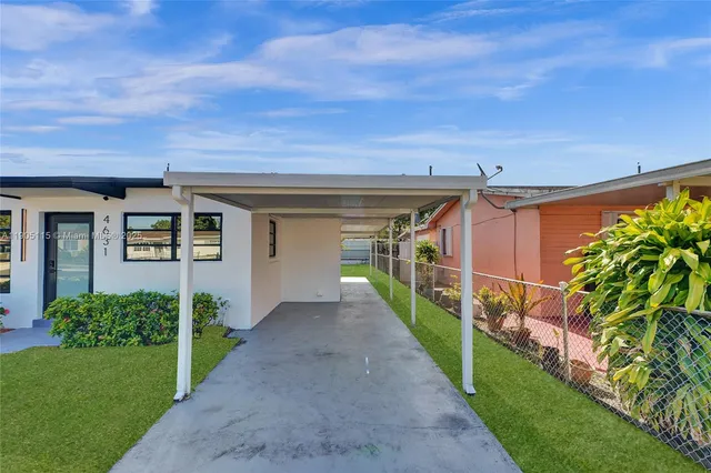 a view of a house with a yard and pathway