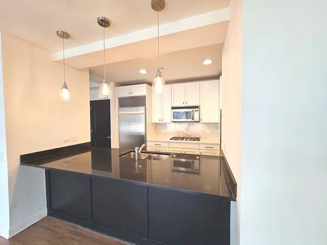 a kitchen with stainless steel appliances a refrigerator and a stove