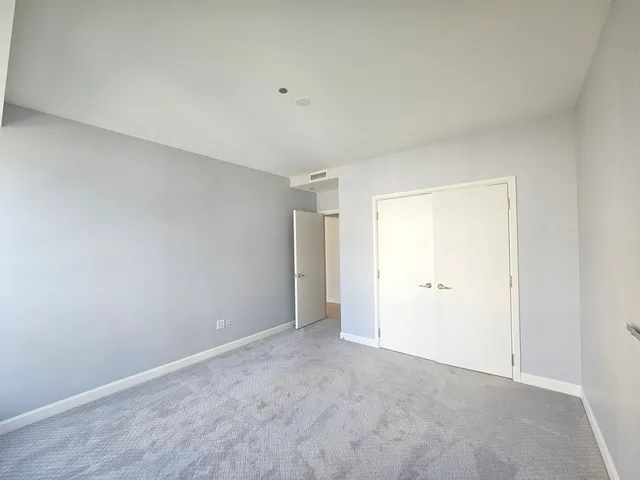 a bathroom with a granite countertop sink toilet mirror and bathtub