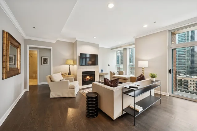 a living room with furniture a fireplace and a table