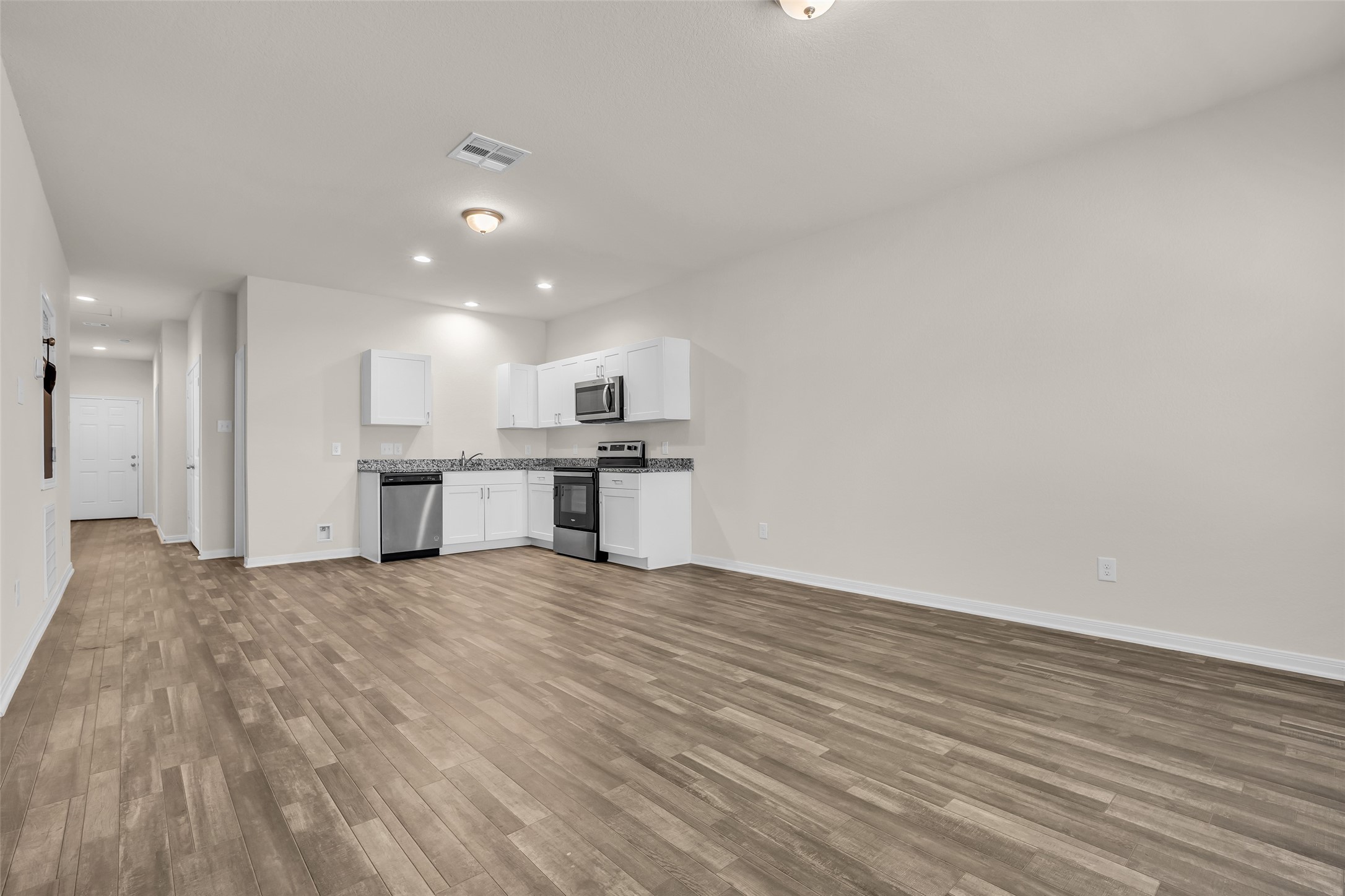 2511 17th Street Hempstead, TX 77445 - Photo 12 of 23 a view of kitchen with granite countertop cabinets and refrigerator
