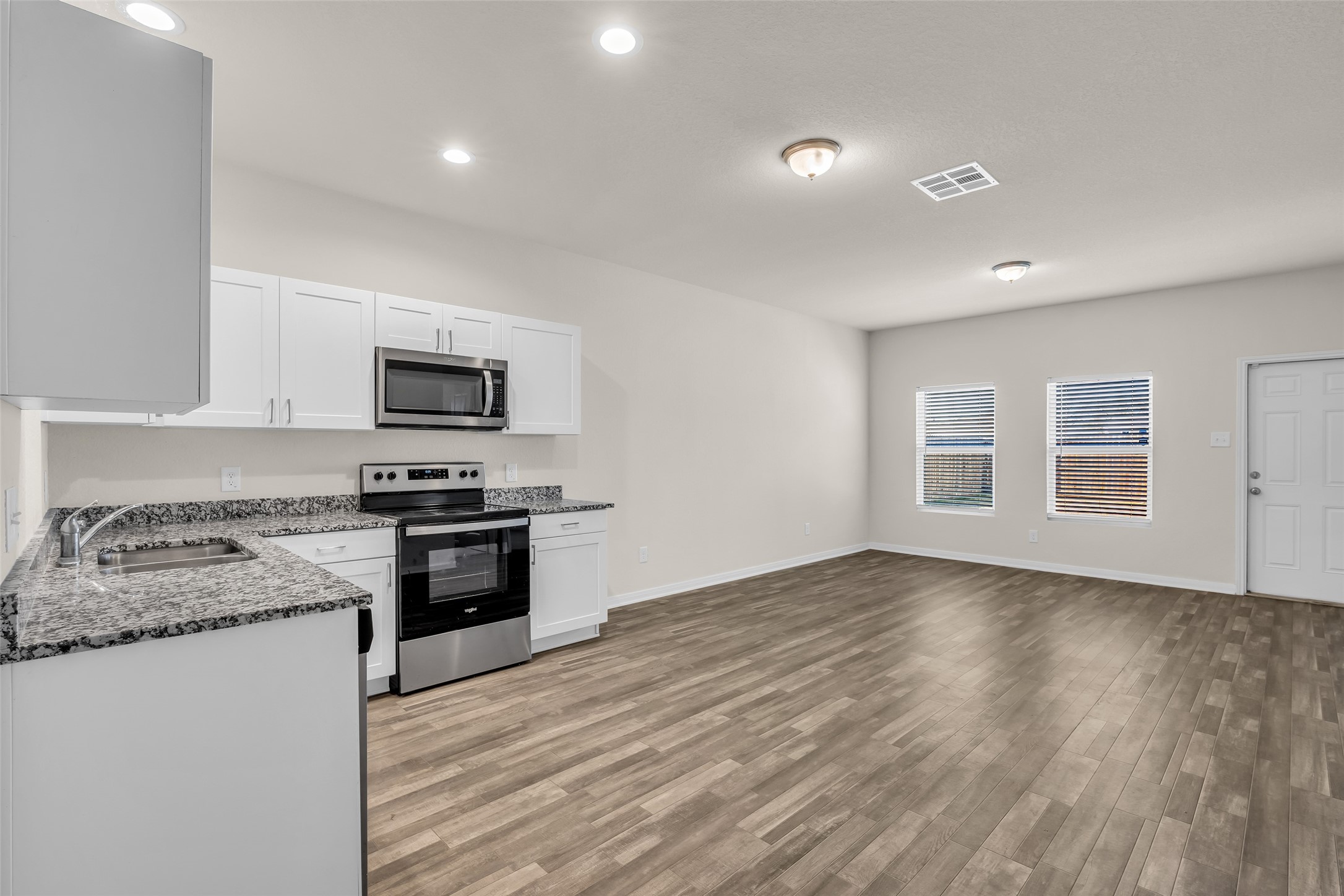 2511 17th Street Hempstead, TX 77445 - Photo 2 of 23 a kitchen with granite countertop a stove top oven sink and cabinets
