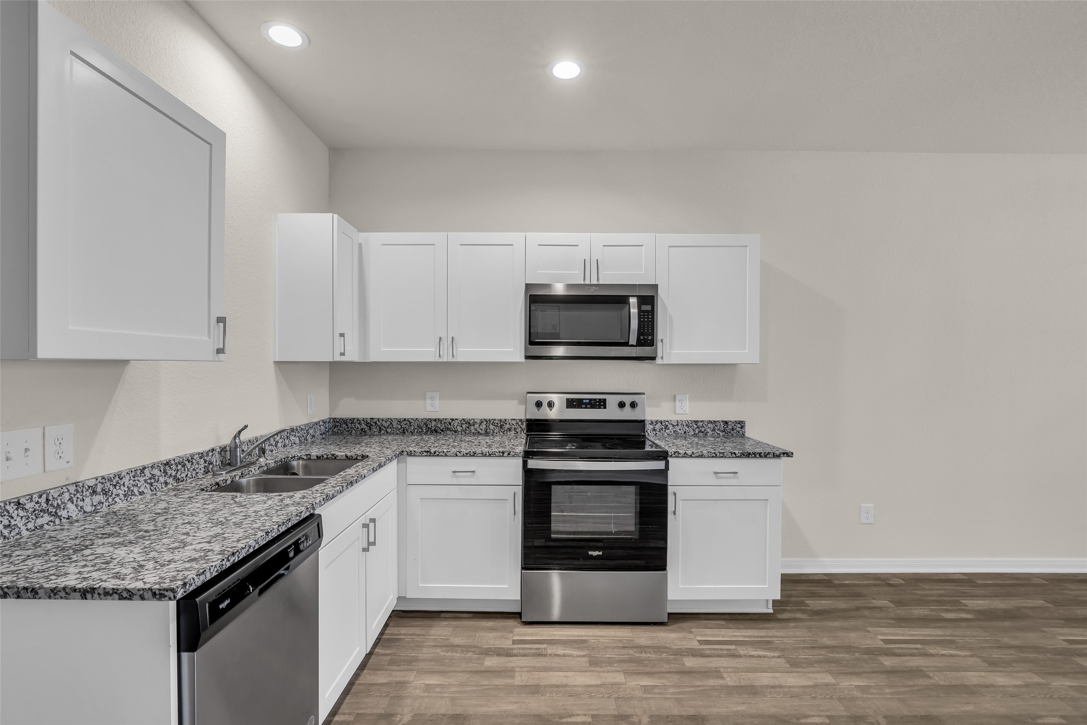 2511 17th Street Hempstead, TX 77445 - Photo 3 of 23 a kitchen with granite countertop white cabinets and stainless steel appliances
