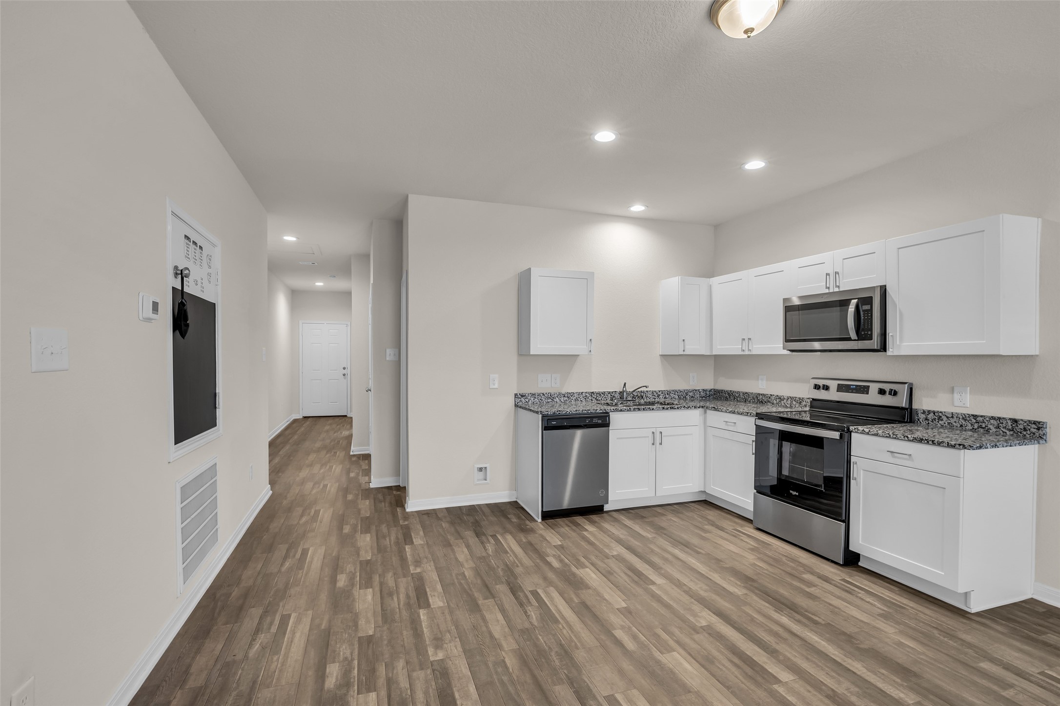 2511 17th Street Hempstead, TX 77445 - Photo 4 of 23 a large kitchen with stainless steel appliances granite countertop a stove and a refrigerator