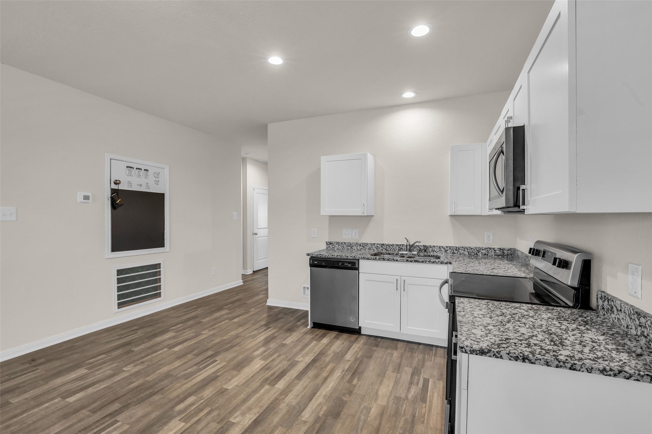 2511 17th Street Hempstead, TX 77445 - Photo 6 of 23 a kitchen with stainless steel appliances granite countertop a stove a sink and a refrigerator