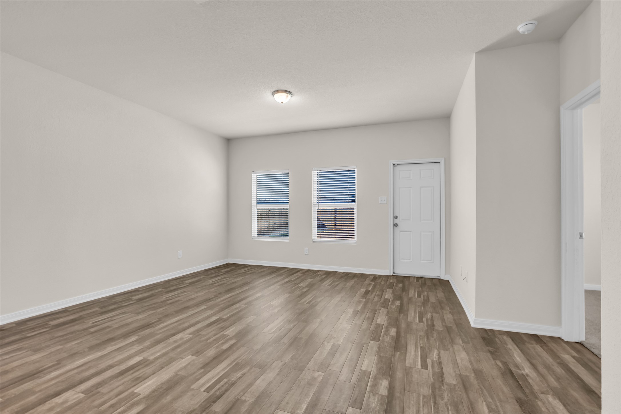 2511 17th Street Hempstead, TX 77445 - Photo 8 of 23 wooden floor in an empty room with a window