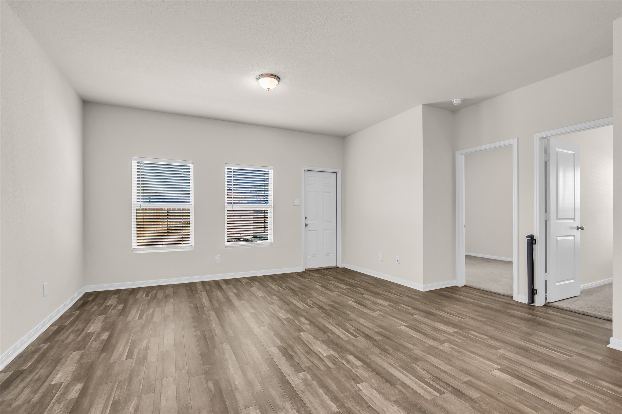 2511 17th Street Hempstead, TX 77445 - Photo 9 of 23 a view of an empty room with wooden floor and a window