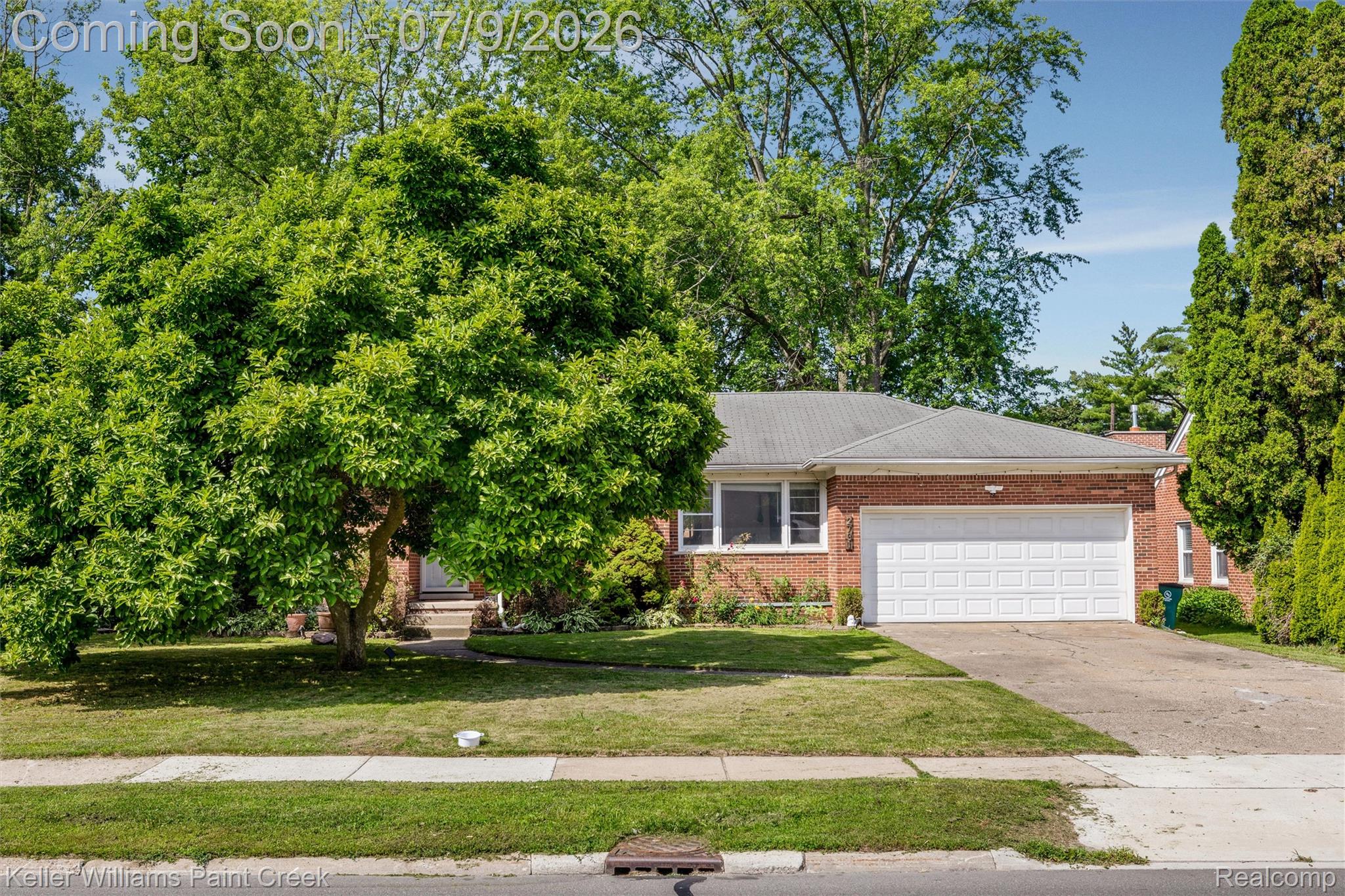 2731 Crooks Road Royal Oak, MI 48073 - Photo 29 of 34 Brick-front residence featuring a two-car garage, mature front yard trees, concrete driveway, and a shingle roof